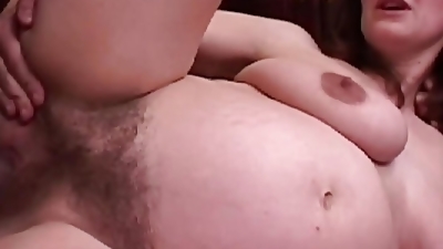Busty pregnant brunette fucks a big black cock