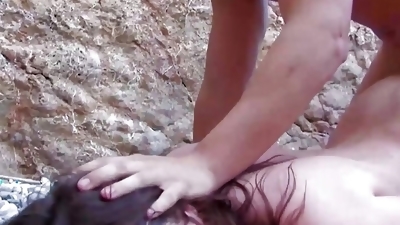 Round ass German slut gets banged on the beach by two cocks