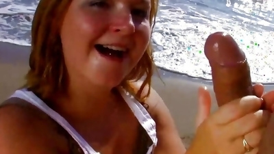 Chubby German slut pleasing a hard cock dude on the beach