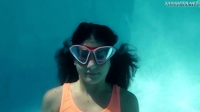 Flexible brunette babe Micha shows off her gymnastics skills underwater
