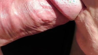 A sunny blowjob in close-up with lots of cum in the mistress's mouth.
