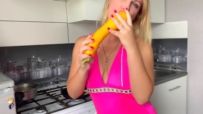 Horny stepmom pleasures herself with a giant zucchini in the kitchen
