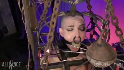 Bald submissive locked in cage with massive ball gag