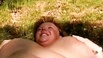 Chubby German lady rubbing her shaved pussy in the woods