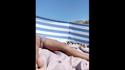 Look at my beautiful pussy. I sunbathe naked on the beach in front of people